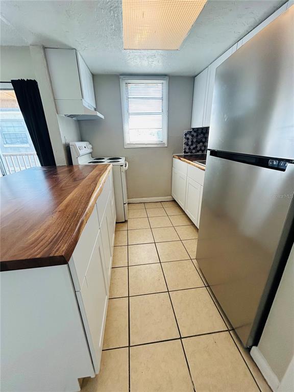 2777 L B McLeod Road, Unit D Orlando, FL 32805 - Photo 3 of 10 a kitchen with a sink a refrigerator a window and a stove