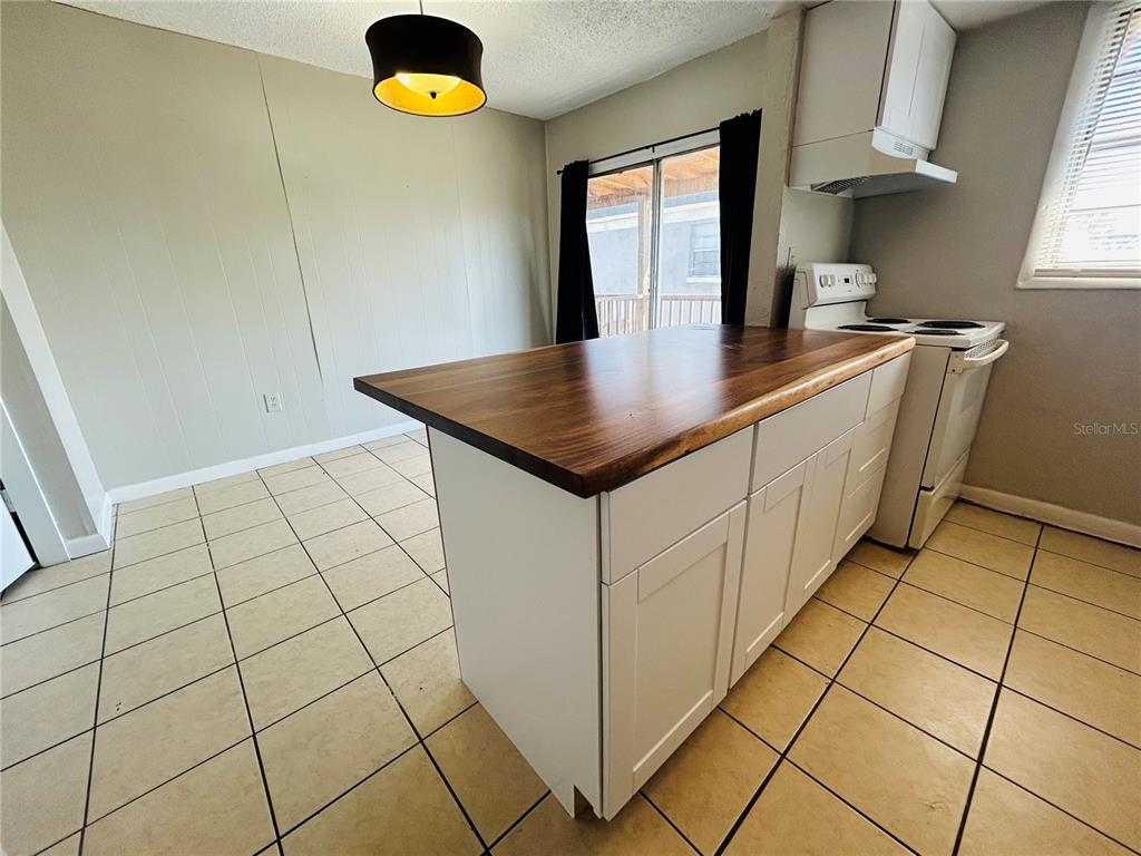 2777 L B McLeod Road, Unit D Orlando, FL 32805 - Photo 4 of 10 a kitchen with cabinets and window