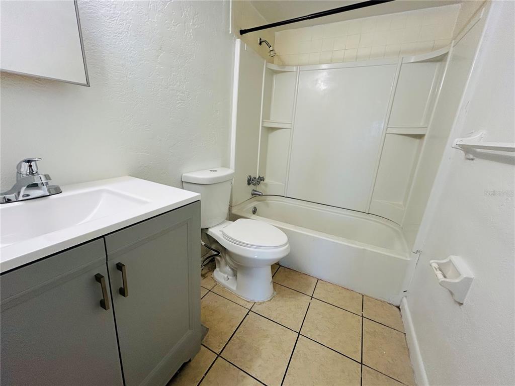 2777 L B McLeod Road, Unit D Orlando, FL 32805 - Photo 5 of 10 a bathroom with a sink a toilet and shower