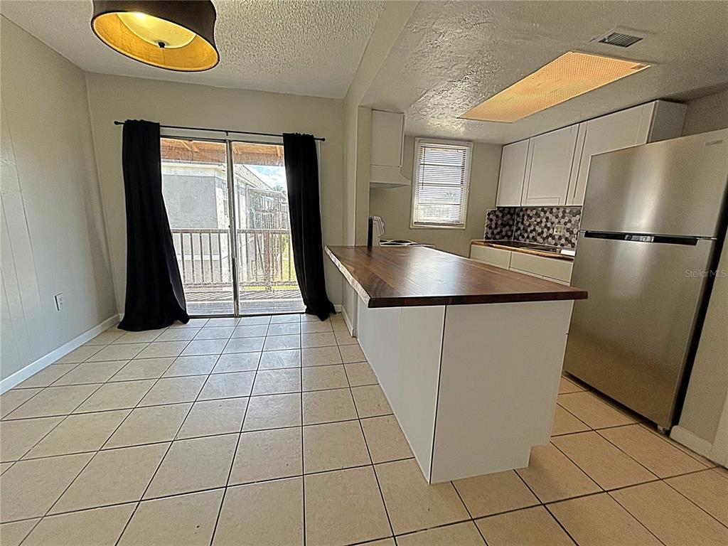 2777 L B McLeod Road, Unit D Orlando, FL 32805 - Photo 8 of 10 a view of a kitchen with a sink and a refrigerator