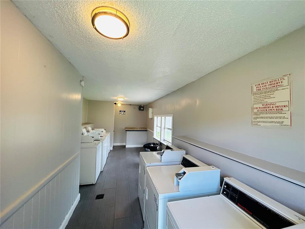 2777 L B McLeod Road, Unit D Orlando, FL 32805 - Photo 9 of 10 a hallway with a couch and chandelier