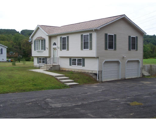 56 Shea Road West Brookfield, MA 01585 - Photo 1 of 6 a front view of a house with a yard