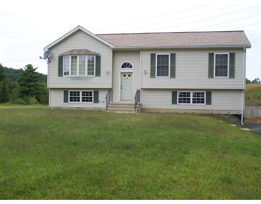 56 Shea Road West Brookfield, MA 01585 - Photo 2 of 6 a front view of a house with a yard