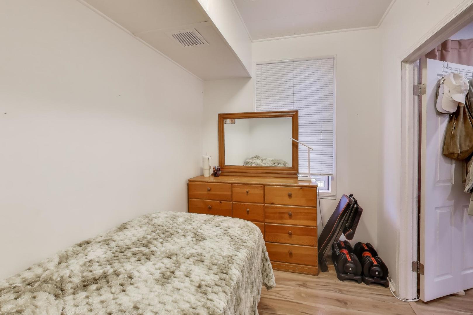 3248 South Paulina Street Chicago, IL 60608 - Photo 11 of 43 a bedroom with a bed and wooden floor