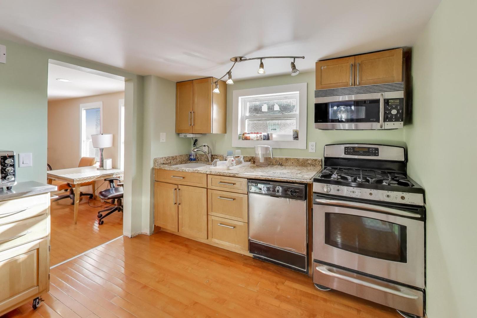 3248 South Paulina Street Chicago, IL 60608 - Photo 19 of 43 a kitchen with stainless steel appliances a stove a sink and a microwave