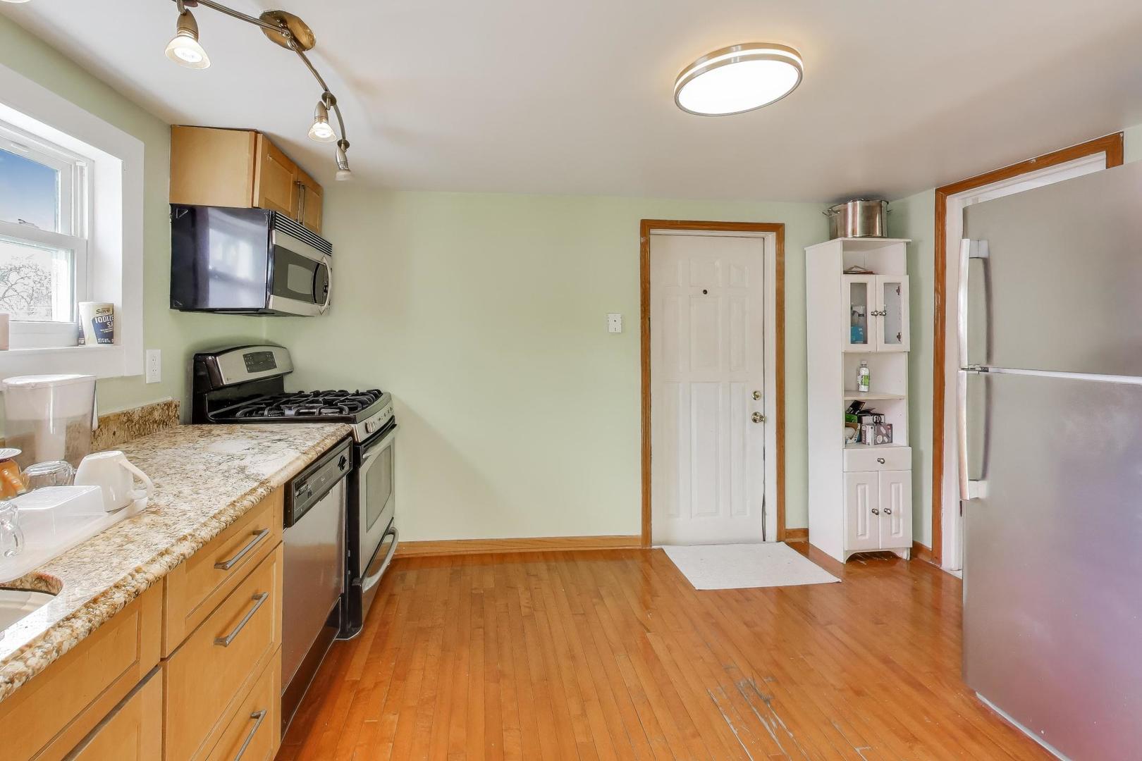 3248 South Paulina Street Chicago, IL 60608 - Photo 20 of 43 a kitchen with a refrigerator and a sink