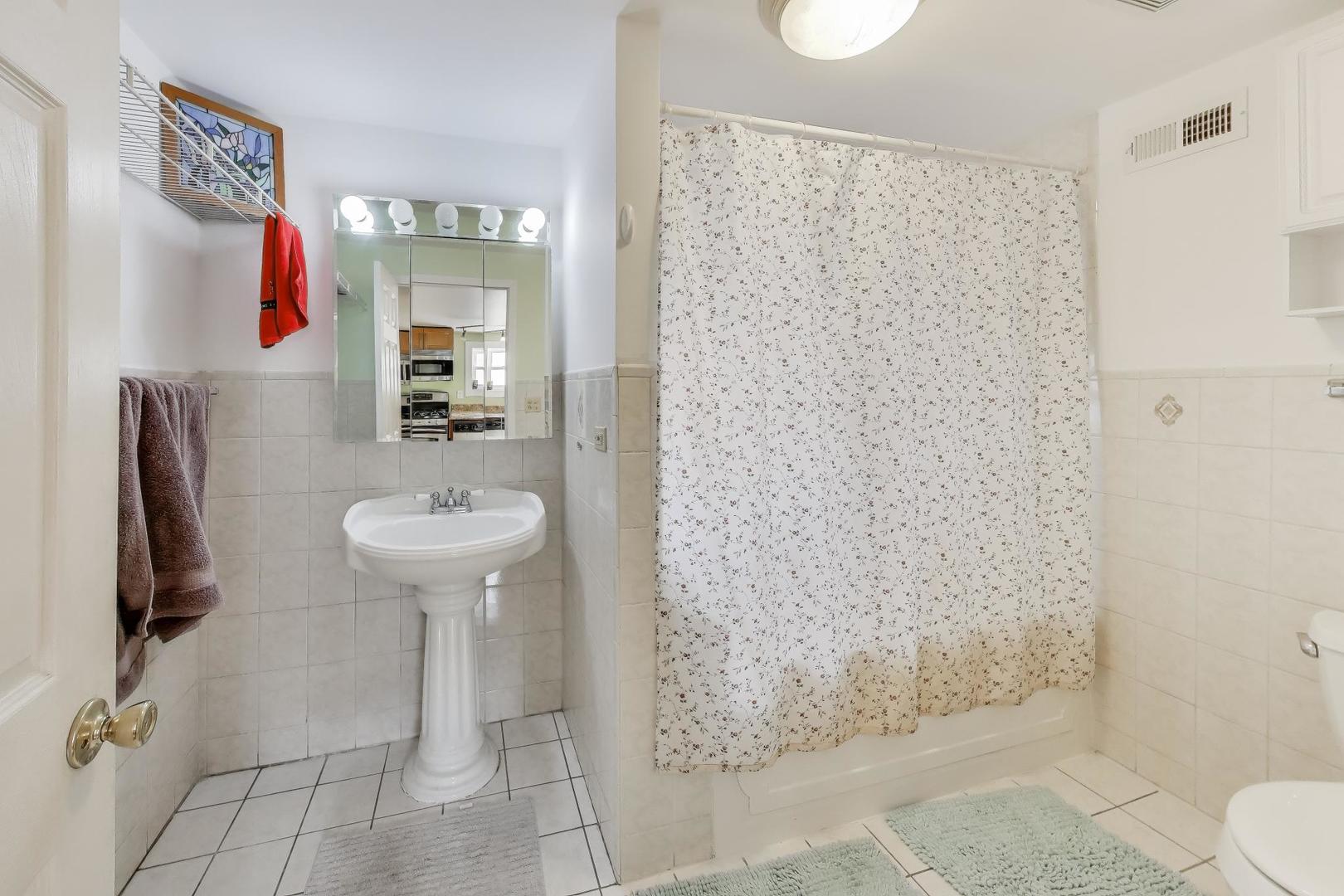 3248 South Paulina Street Chicago, IL 60608 - Photo 22 of 43 a bathroom with a sink toilet and shower