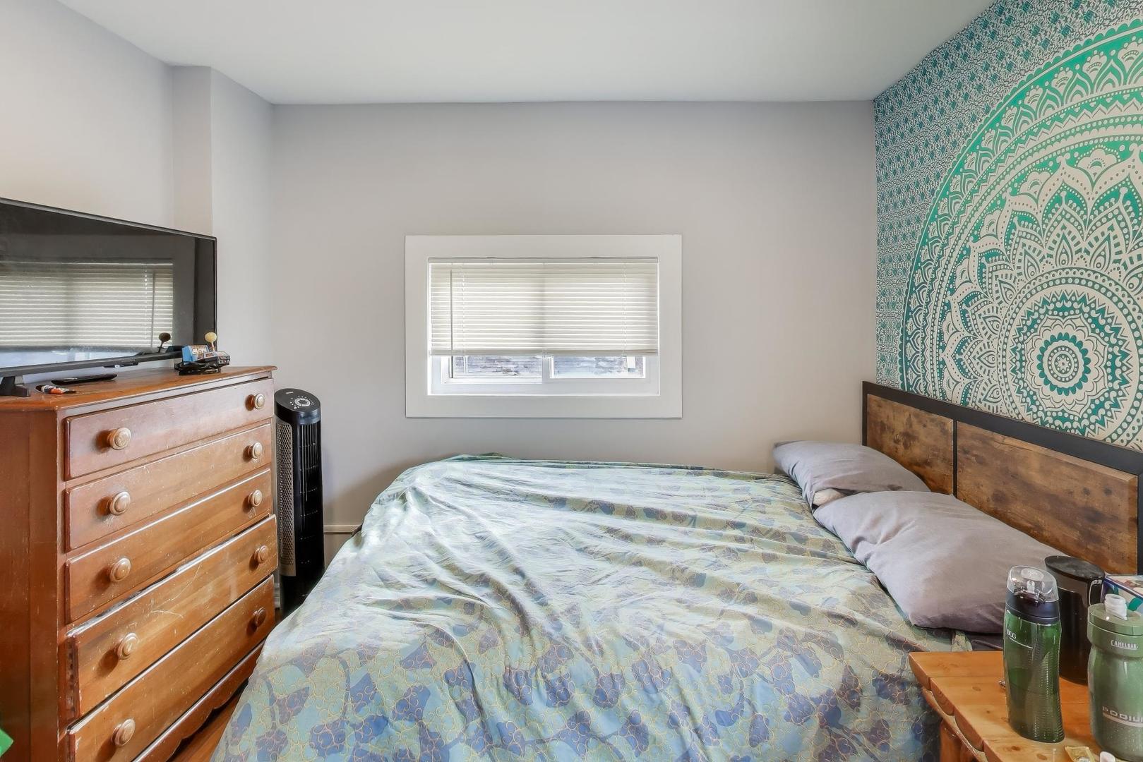 3248 South Paulina Street Chicago, IL 60608 - Photo 25 of 43 a bedroom with a bed and a tv in it