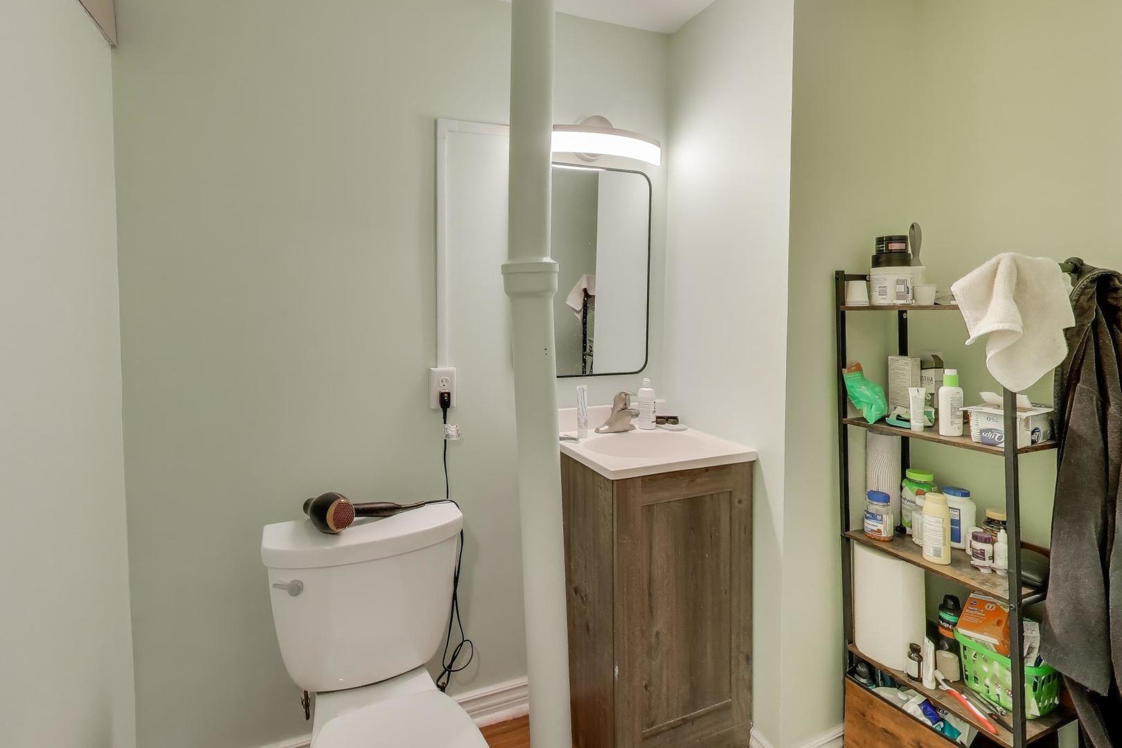 3248 South Paulina Street Chicago, IL 60608 - Photo 27 of 43 a bathroom with a toilet sink and mirror