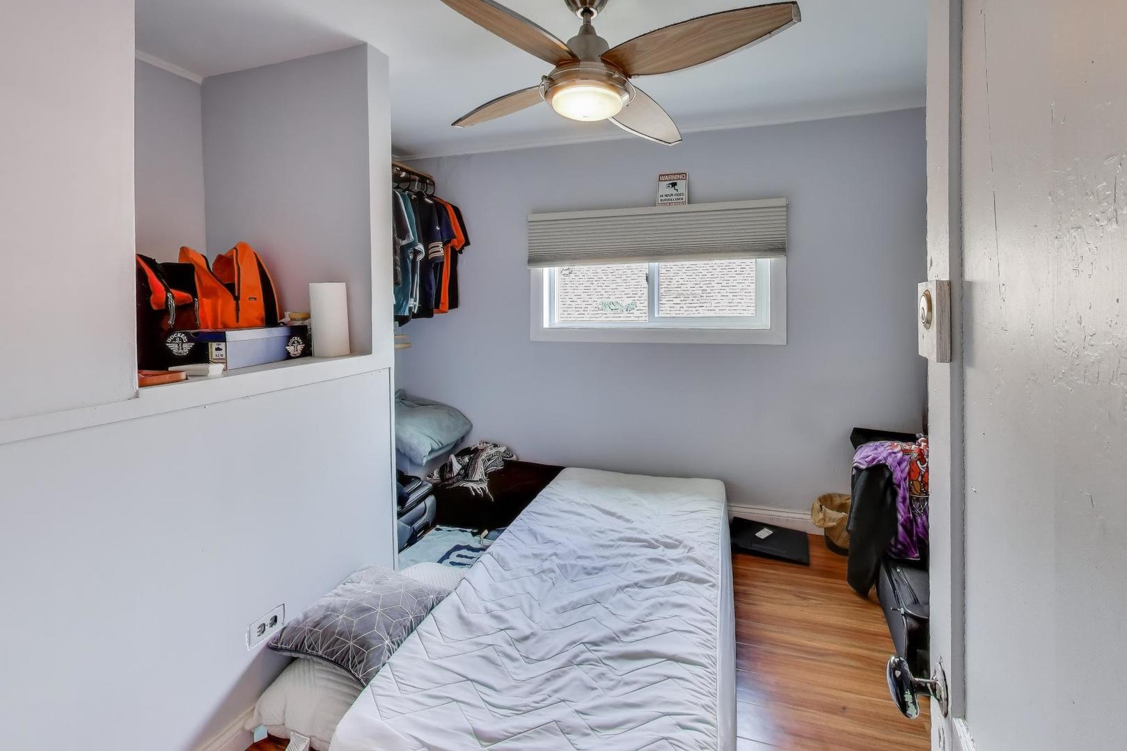 3248 South Paulina Street Chicago, IL 60608 - Photo 30 of 43 a bedroom with a bed and a chandelier