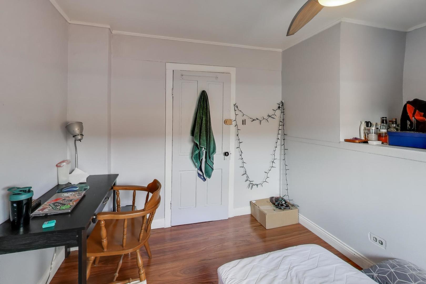 3248 South Paulina Street Chicago, IL 60608 - Photo 31 of 43 a bedroom with a bed and a chair in it