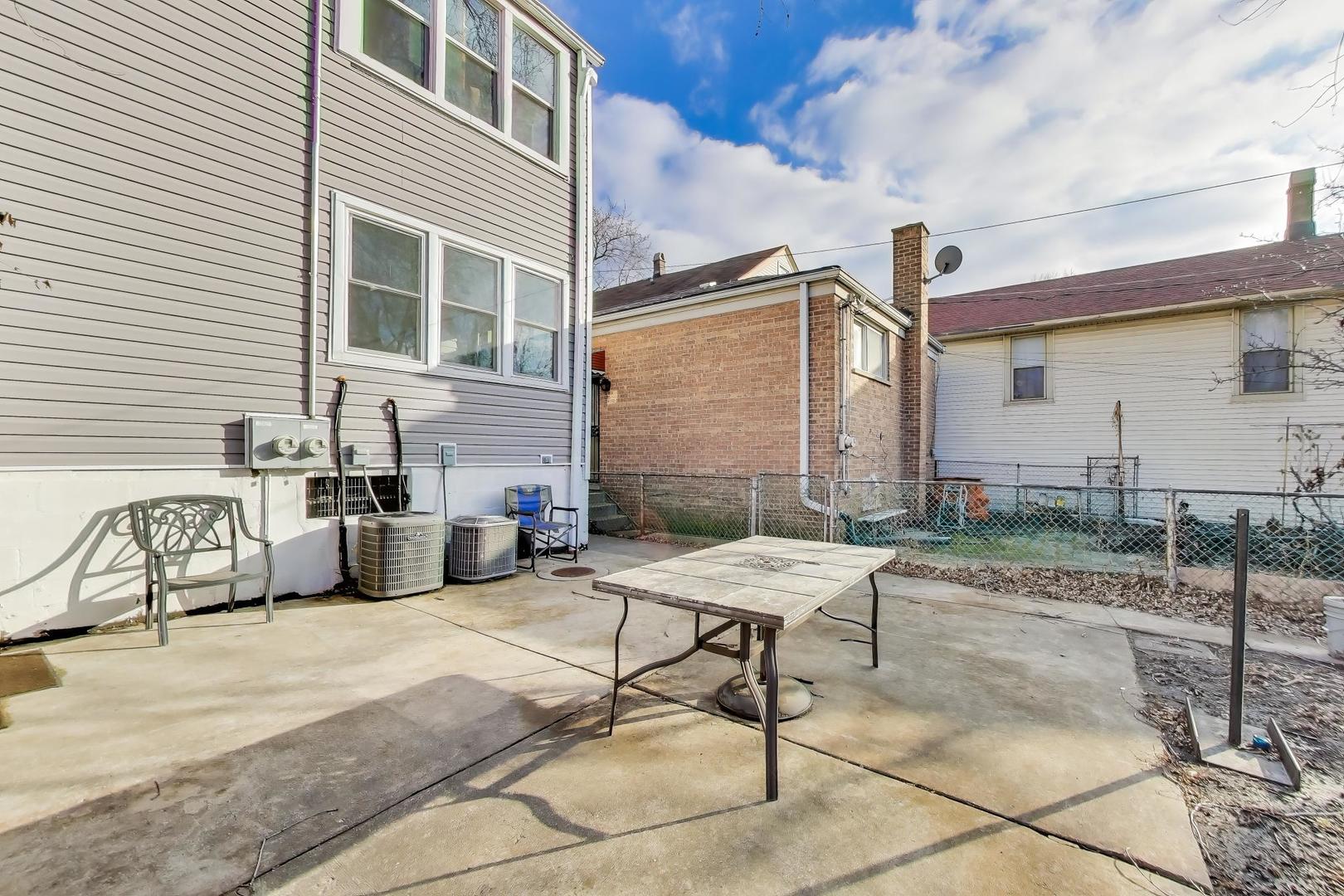 3248 South Paulina Street Chicago, IL 60608 - Photo 38 of 43 a table and chairs in front of a house