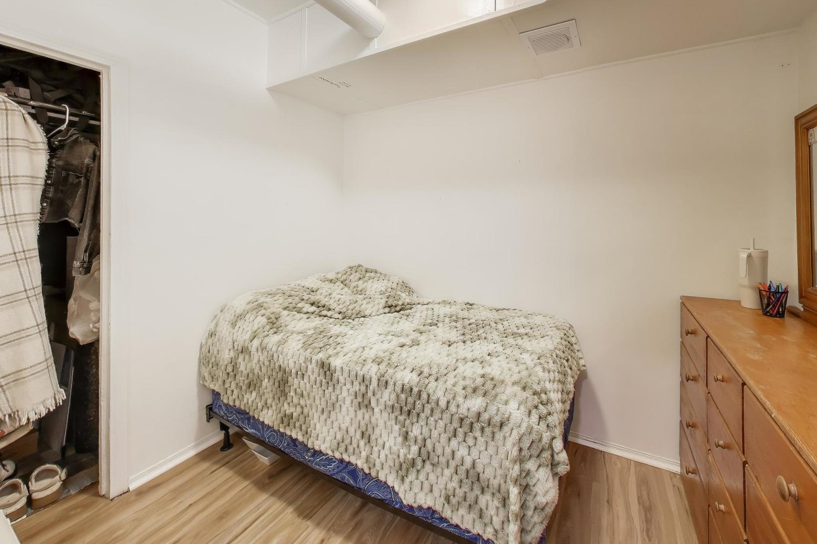 3248 South Paulina Street Chicago, IL 60608 - Photo 10 of 43 a bedroom with a bed and wooden floor