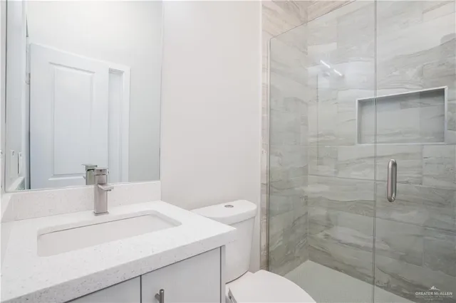 an empty room with a window and hardwood floor