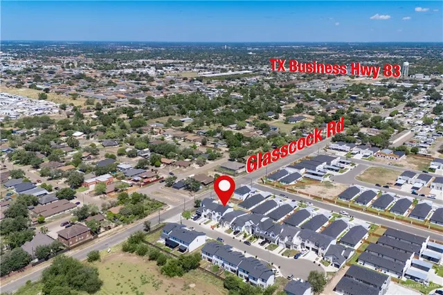 an aerial view of residential houses with outdoor space