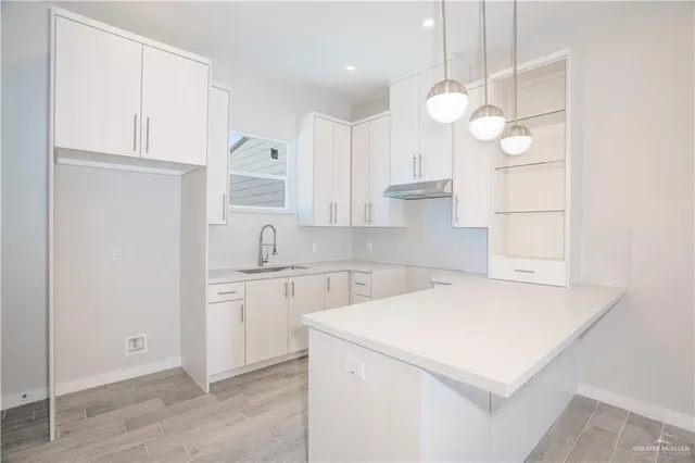 a bathroom with a sink a mirror and a shower