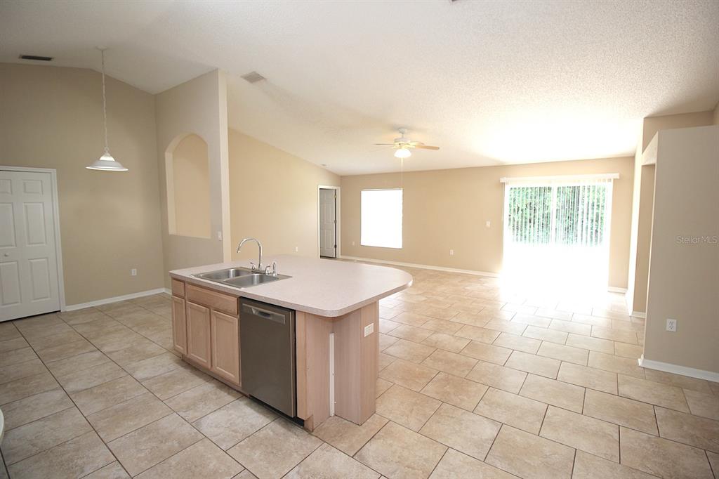 32 Ryding Lane Palm Coast, FL 32164 - Photo 11 of 38 a kitchen with stainless steel appliances granite countertop a sink and a stove