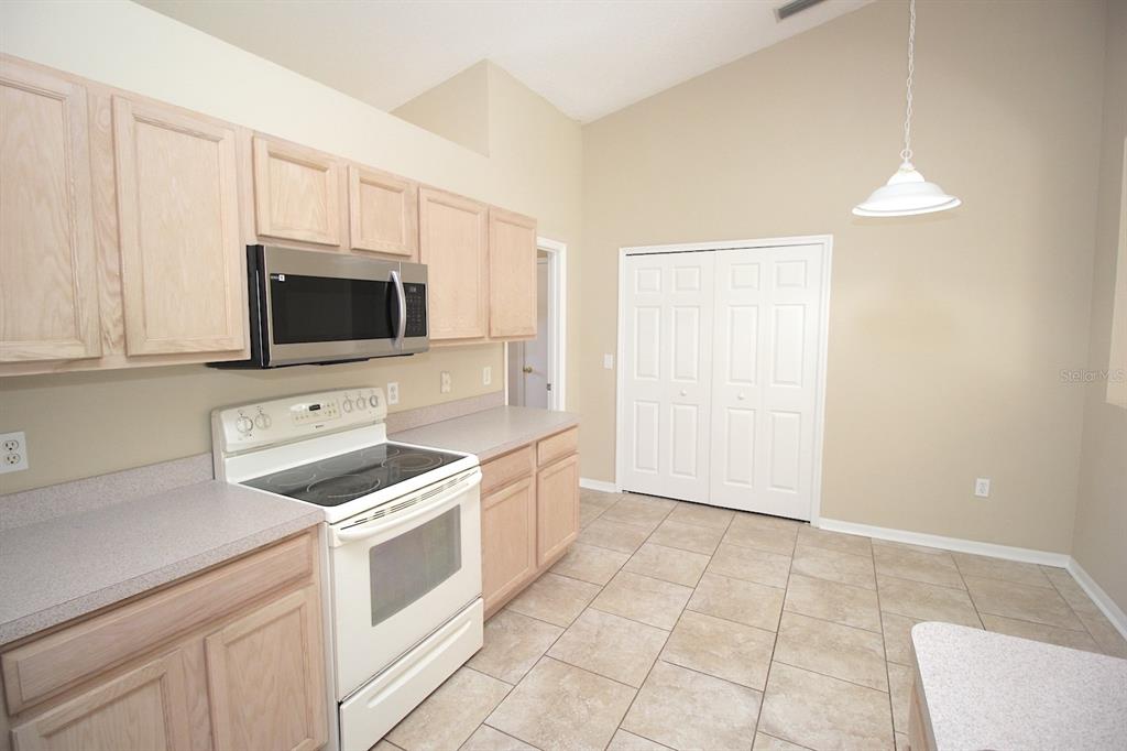 32 Ryding Lane Palm Coast, FL 32164 - Photo 15 of 38 a kitchen with a sink and a stove top oven