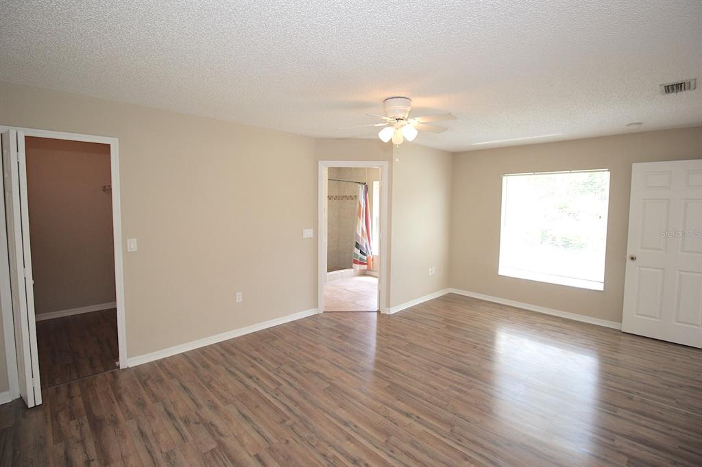 32 Ryding Lane Palm Coast, FL 32164 - Photo 23 of 38 an empty room with wooden floor and windows