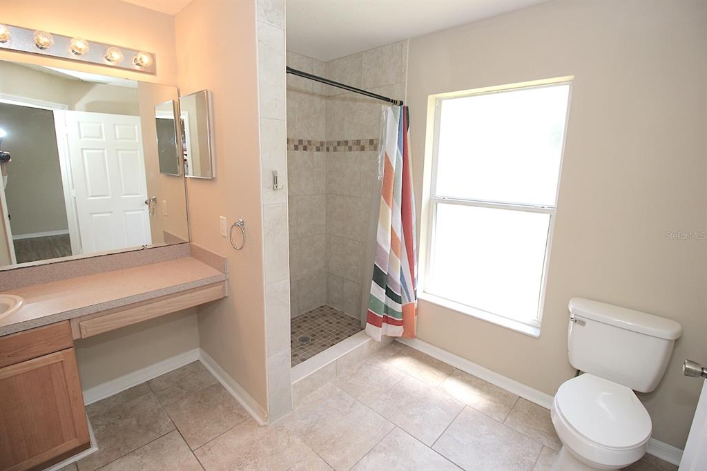 32 Ryding Lane Palm Coast, FL 32164 - Photo 25 of 38 a bathroom with a sink toilet and shower