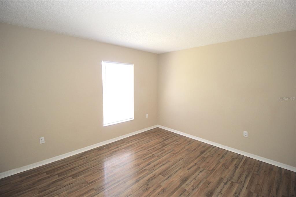 32 Ryding Lane Palm Coast, FL 32164 - Photo 29 of 38 a view of an empty room with wooden floor and a window