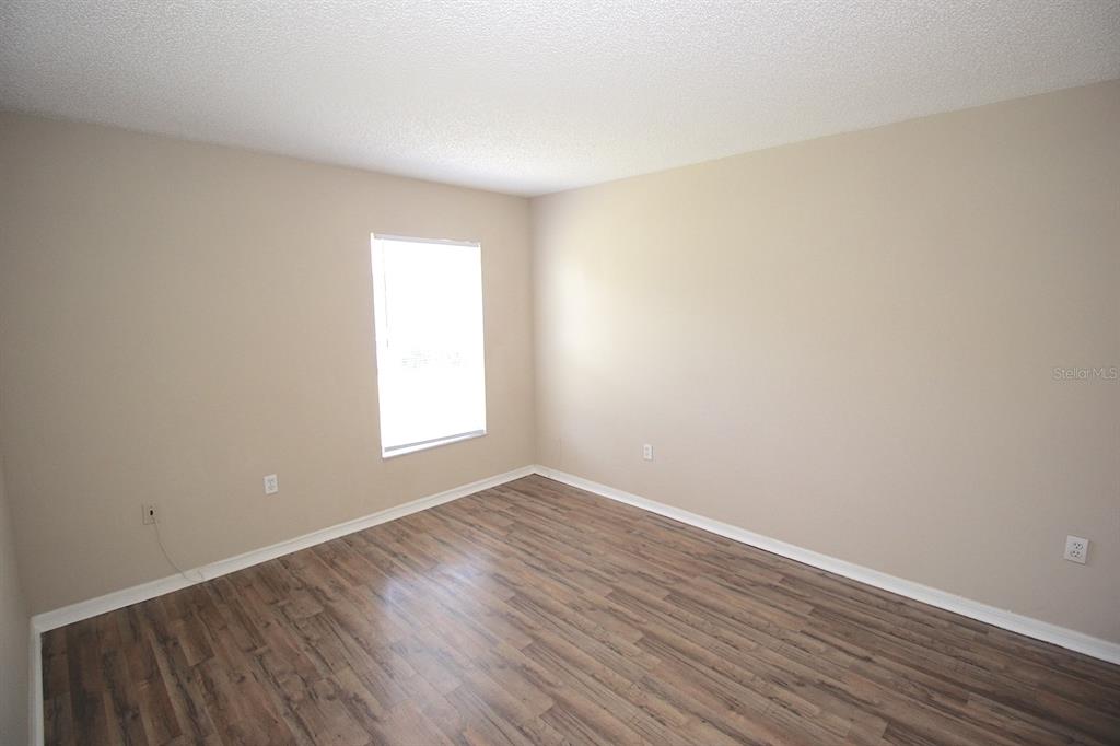32 Ryding Lane Palm Coast, FL 32164 - Photo 31 of 38 a view of an empty room with wooden floor and a window