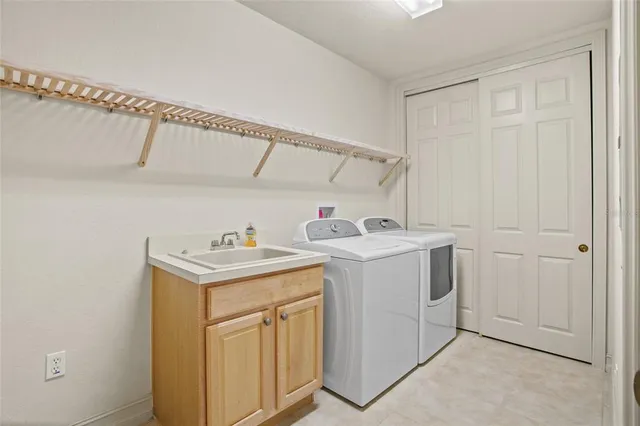 a spacious bedroom with two beds and a dresser