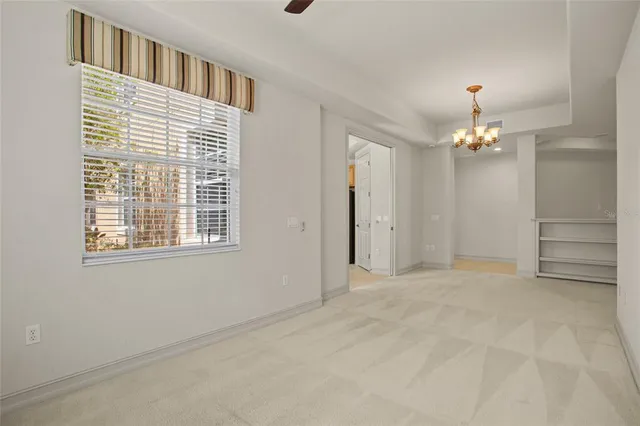 an empty room with a ceiling fan and closet