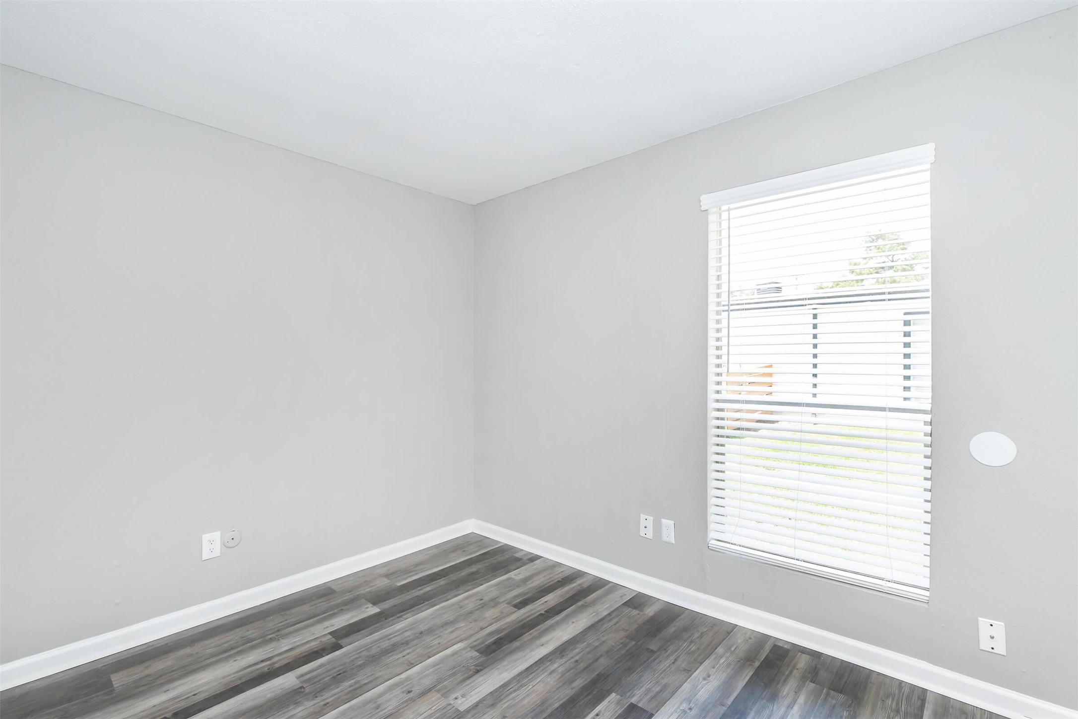 18001 Cypress Trace Road, Unit 305 Houston, TX 77090 - Photo 14 of 34 a view of an empty room with wooden floor and a window
