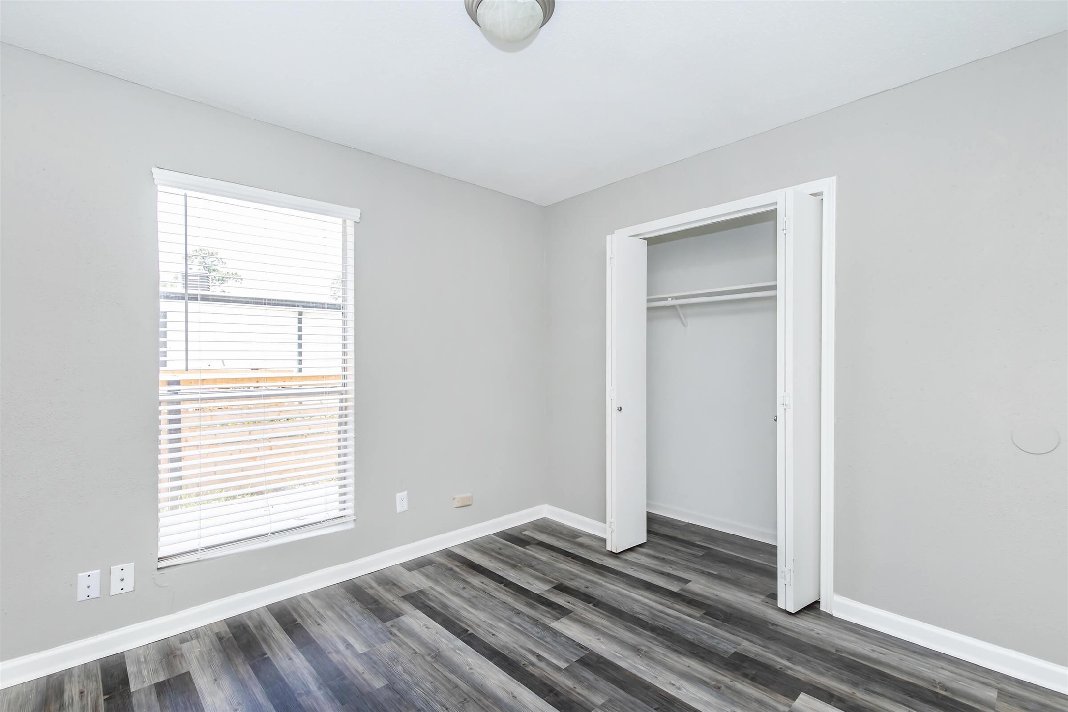 18001 Cypress Trace Road, Unit 305 Houston, TX 77090 - Photo 18 of 34 a view of an empty room with wooden floor and a window