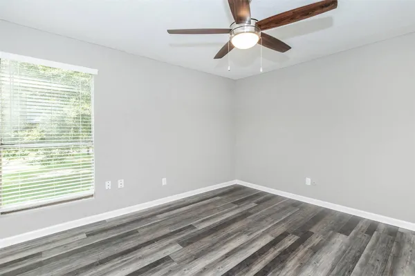 wooden floor in an empty room with a window
