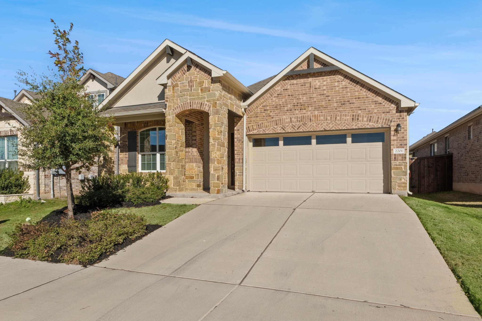 2201 Bobtail Pass Leander, TX 78641 - Photo 1 of 34 a front view of a house with a yard and garage