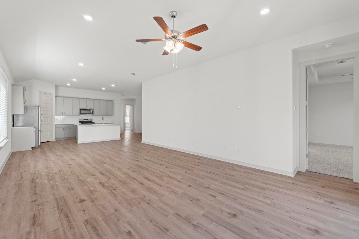 2201 Bobtail Pass Leander, TX 78641 - Photo 13 of 30 a view of empty room with wooden floor and a ceiling fan