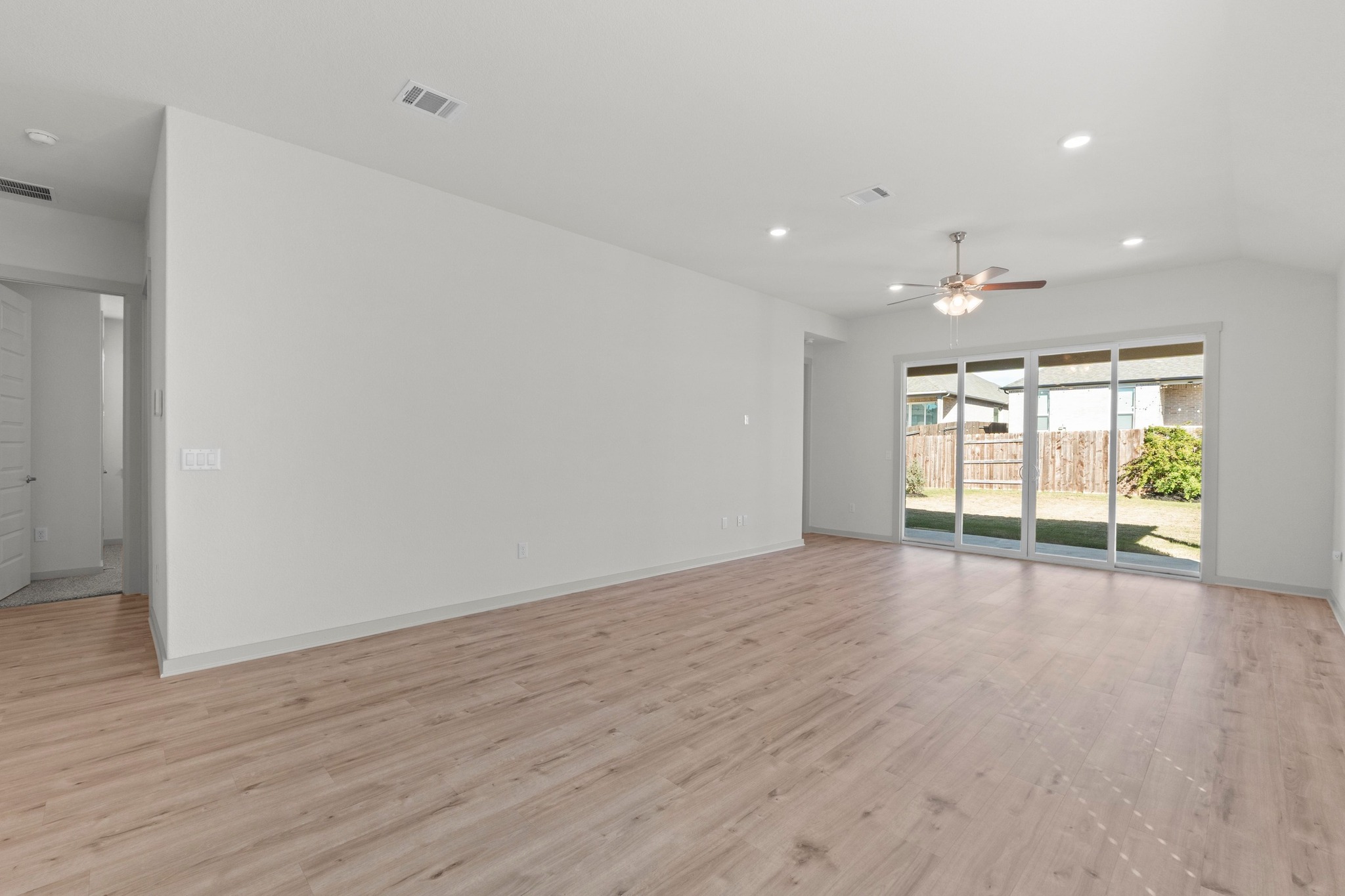 2201 Bobtail Pass Leander, TX 78641 - Photo 13 of 34 a view of an empty room with wooden floor and a window