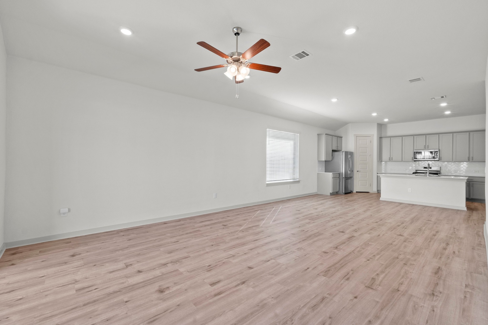2201 Bobtail Pass Leander, TX 78641 - Photo 14 of 34 a view of an empty room with a window and wooden floor