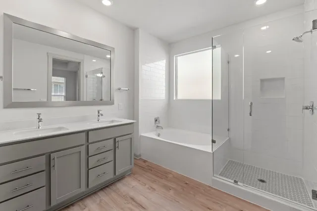a bathroom with a double vanity sink and a mirror