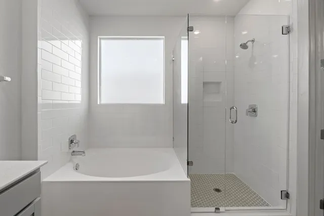 a white bath tub sitting next to a shower