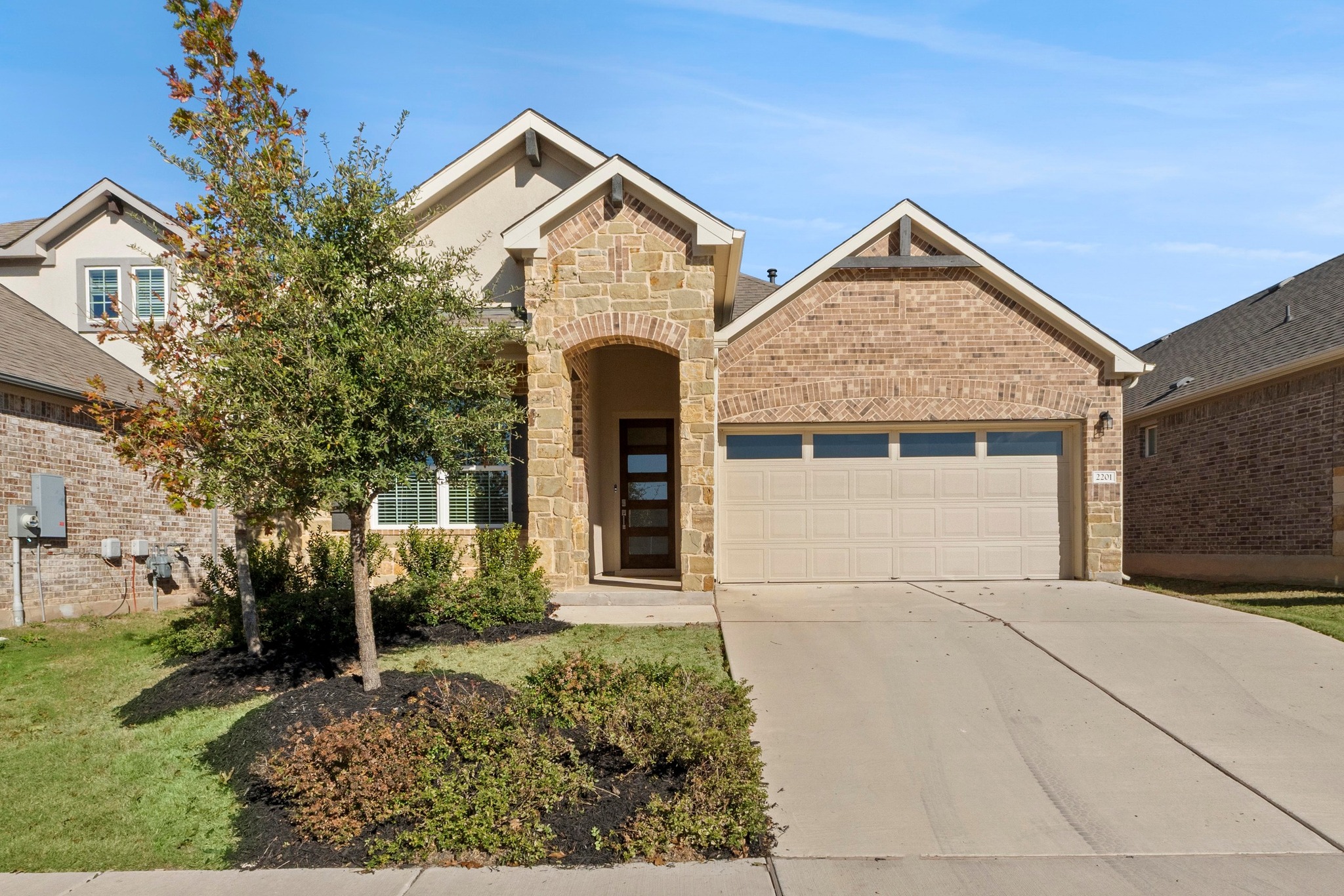 2201 Bobtail Pass Leander, TX 78641 - Photo 2 of 34 a front view of a house with garden