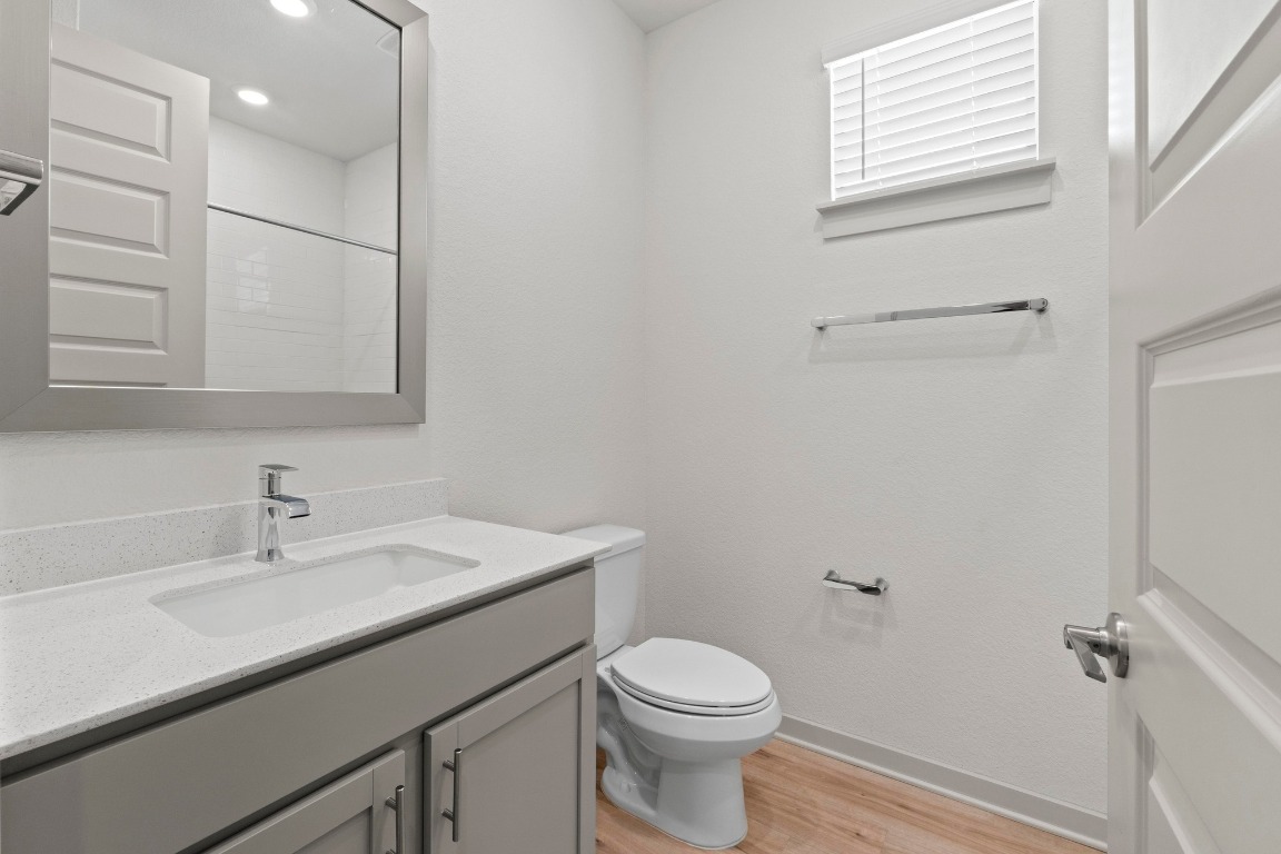 2201 Bobtail Pass Leander, TX 78641 - Photo 22 of 30 a bathroom with a sink a toilet and vanity
