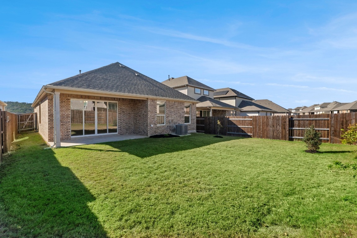 2201 Bobtail Pass Leander, TX 78641 - Photo 28 of 30 a front view of a house with garden