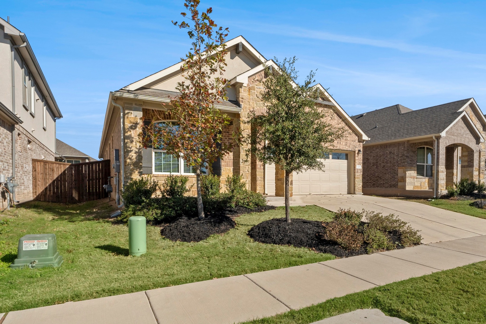 2201 Bobtail Pass Leander, TX 78641 - Photo 3 of 34 a front view of a house with garden