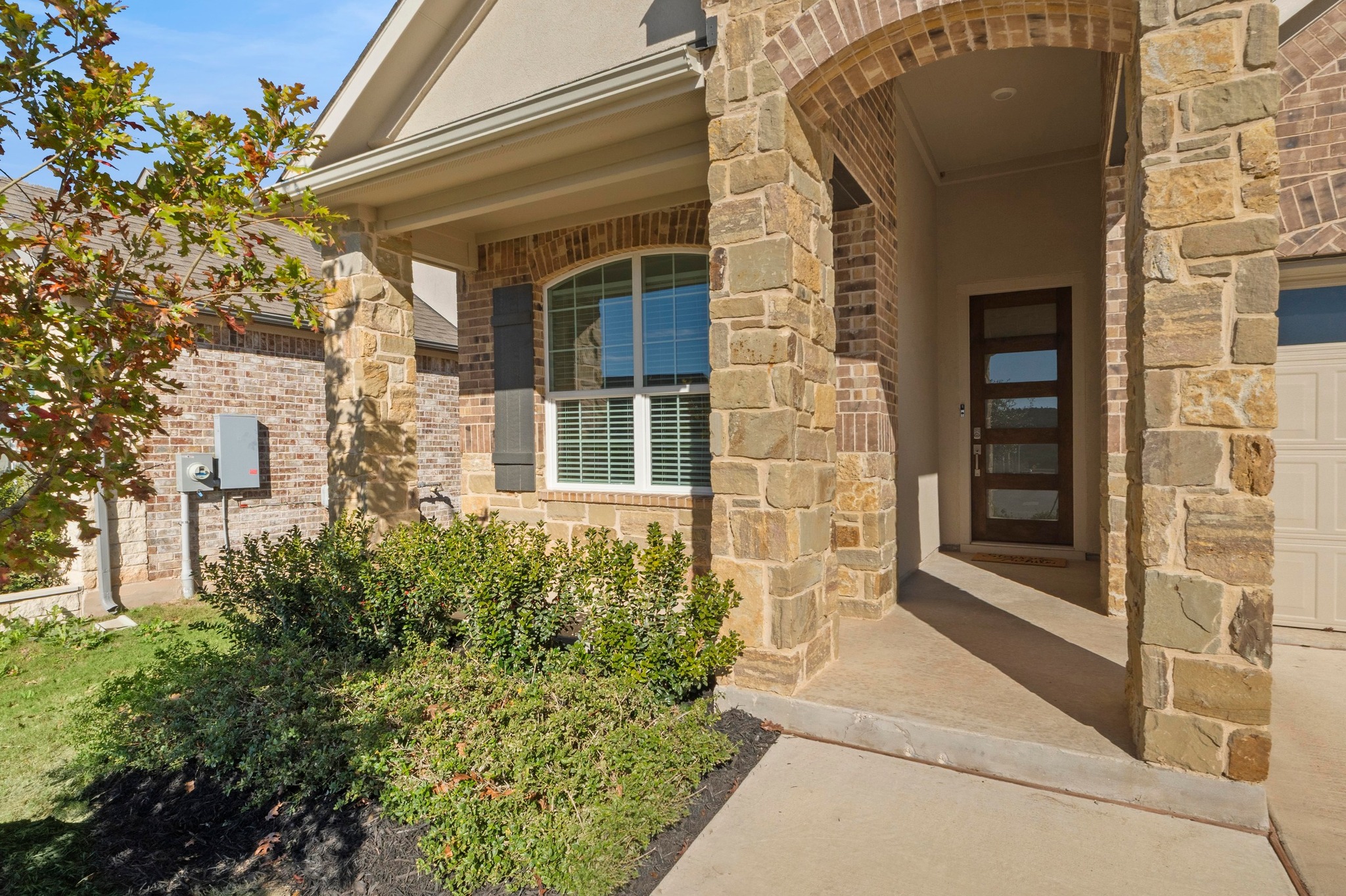 2201 Bobtail Pass Leander, TX 78641 - Photo 4 of 34 front view of a brick house with a large window