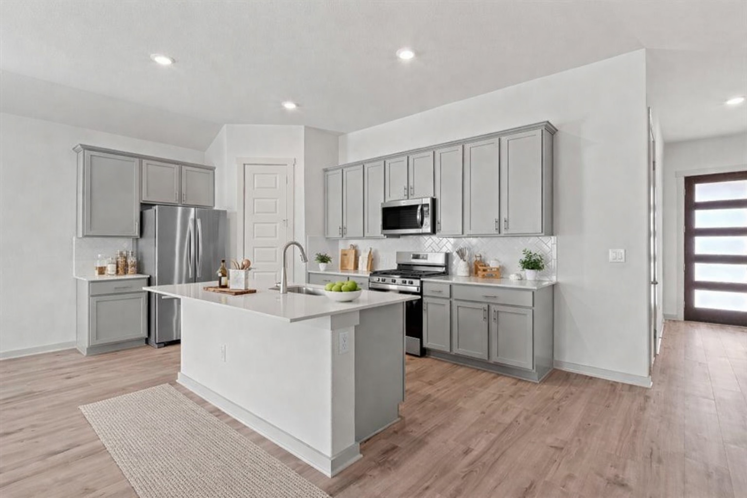 2201 Bobtail Pass Leander, TX 78641 - Photo 5 of 34 a kitchen with cabinets a sink and appliances