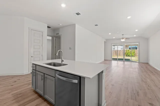 a kitchen with a sink and cabinets