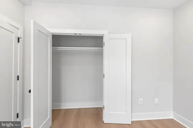 a view of walk in closet with wooden floor