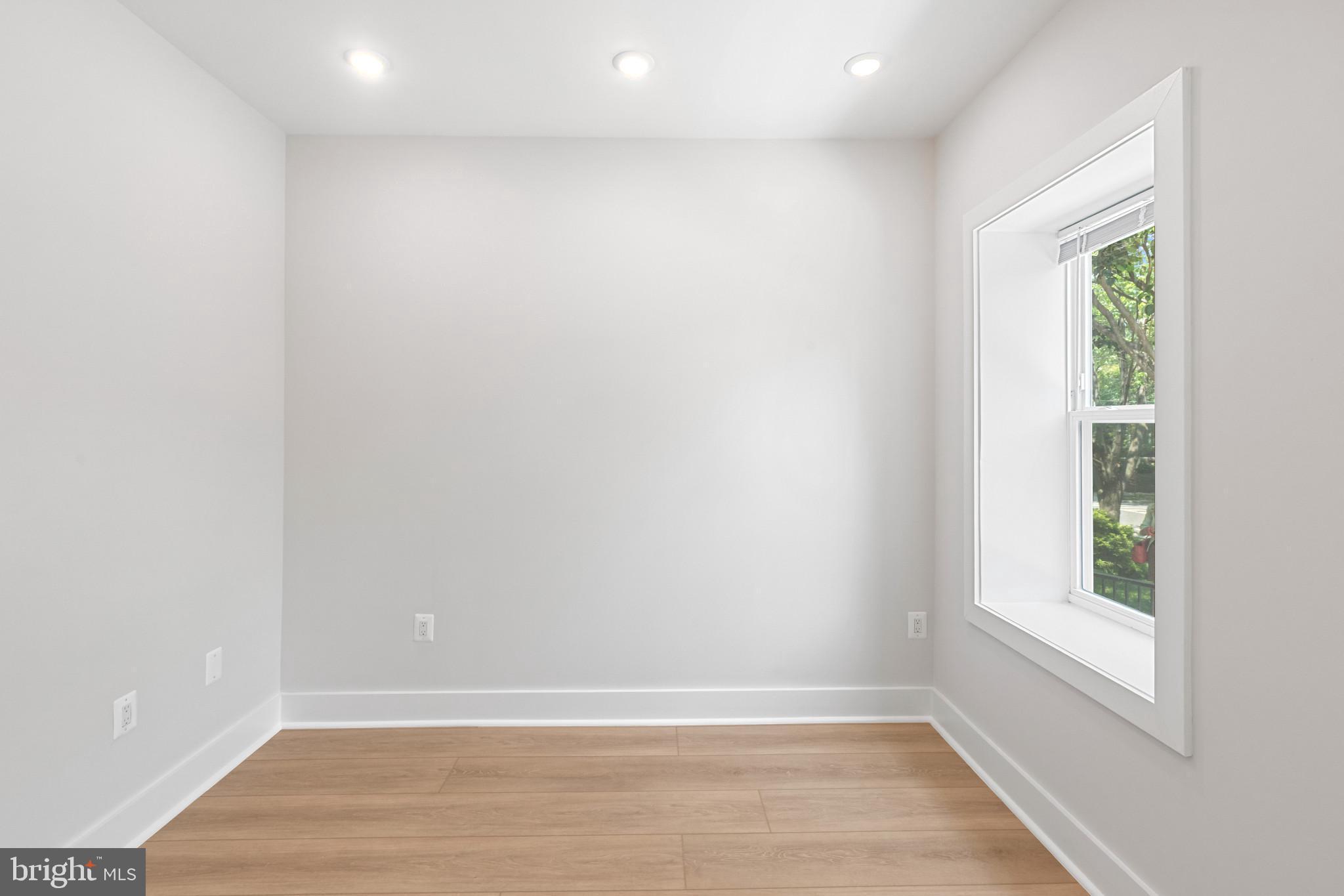 2236 40th Street Northwest, Unit FIVE Washington, DC 20007 - Photo 14 of 37 an empty room with wooden floor and windows