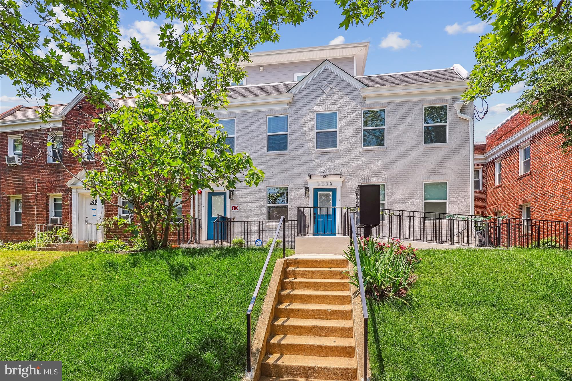 2236 40th Street Northwest, Unit FIVE Washington, DC 20007 - Photo 19 of 37 a front view of a house with a yard