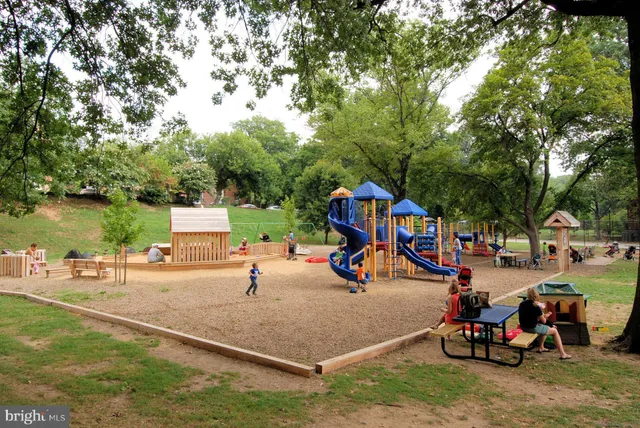 a view of a park with swings and slides