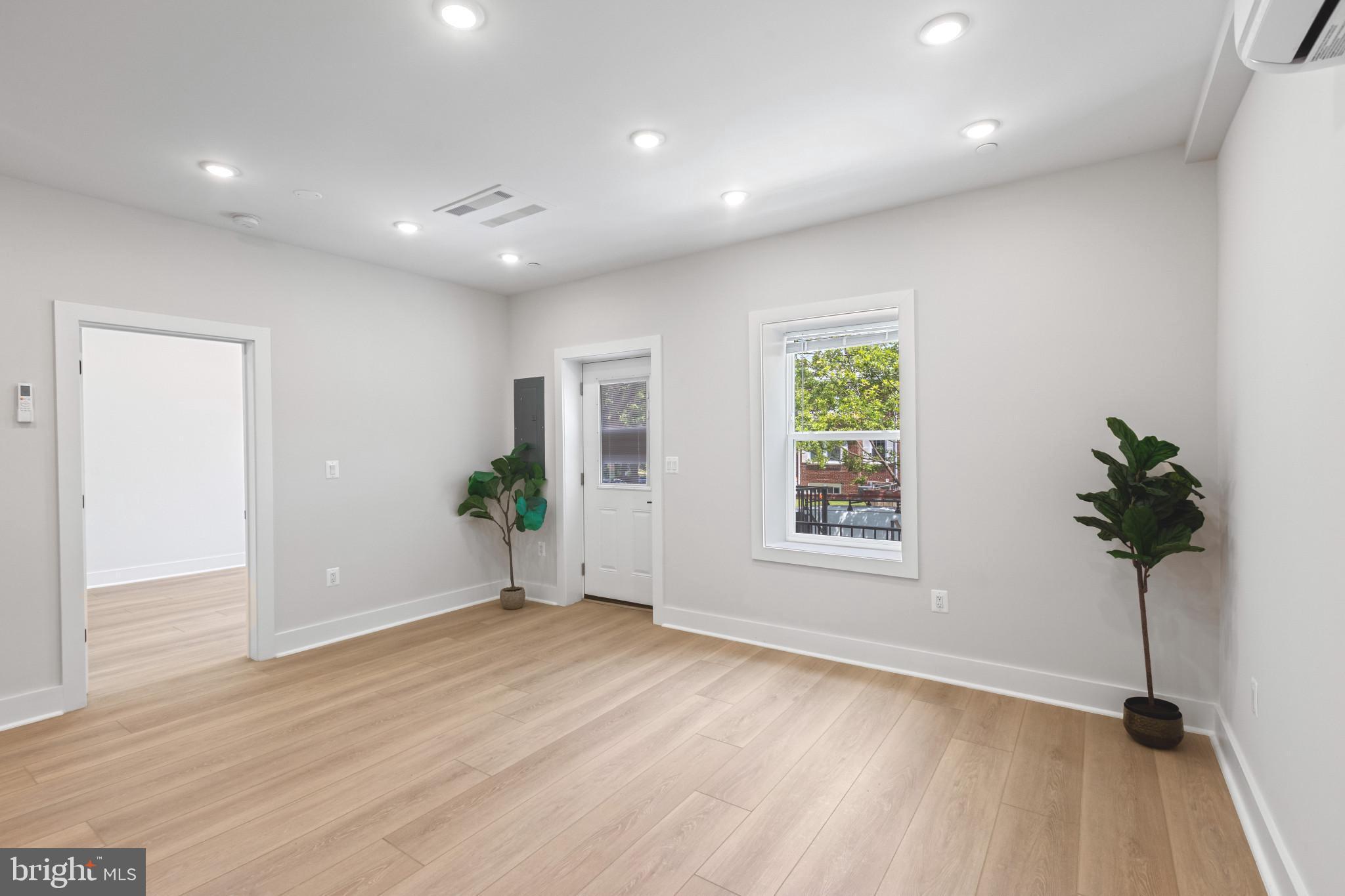 2236 40th Street Northwest, Unit FIVE Washington, DC 20007 - Photo 4 of 37 a view of an empty room with wooden floor and a window
