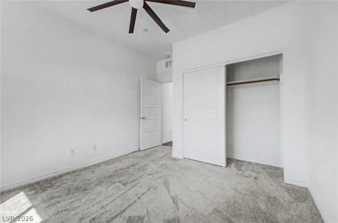 226 Augusta Ridge Henderson, NV 89015 - Photo 16 of 47 This spacious bedroom offers comfortable carpeted flooring, a ceiling fan, and ample closet space.